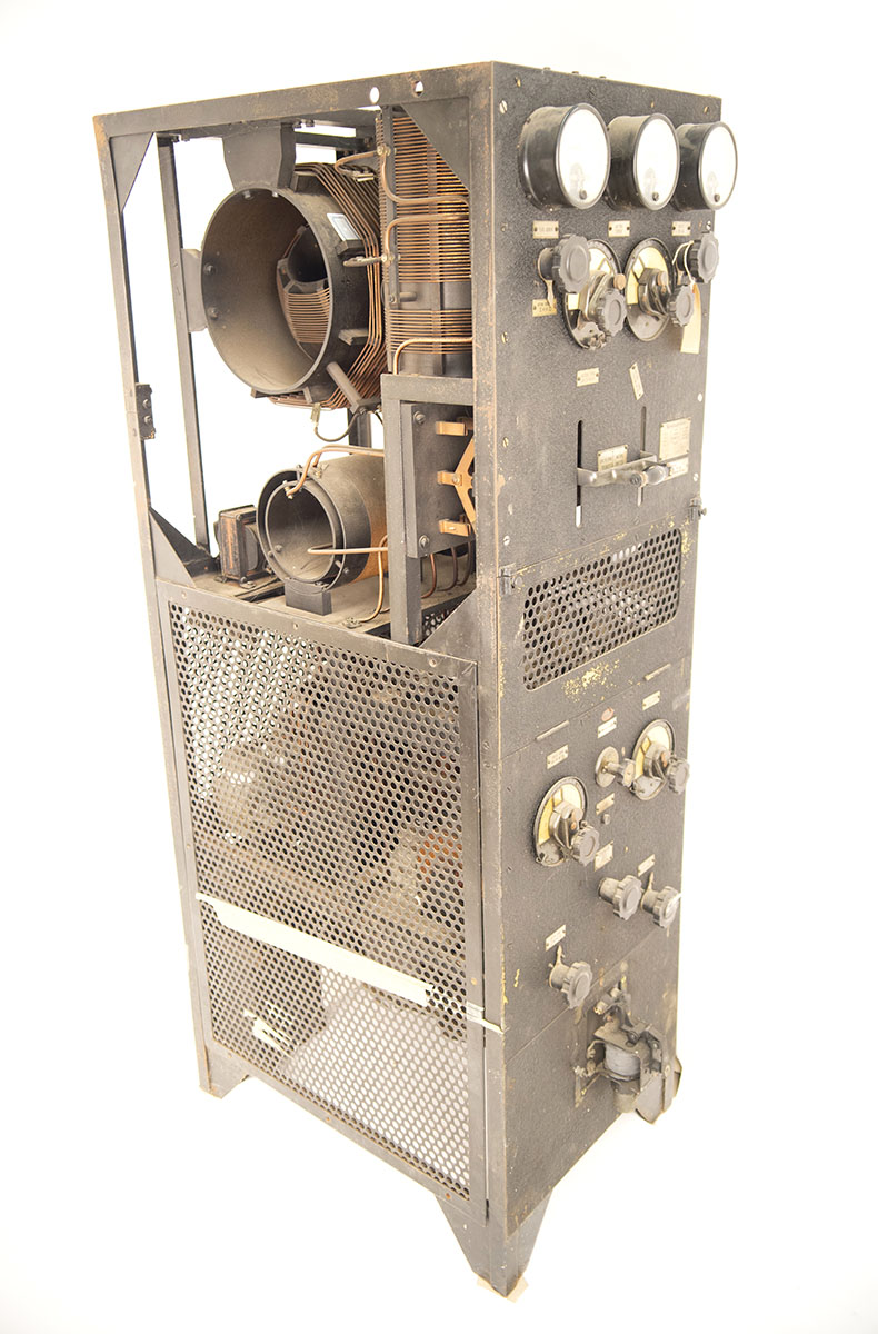 A tall metal rectangular radio with electronic equipment visible A tall metal rectangular radio with electronic equipment visible